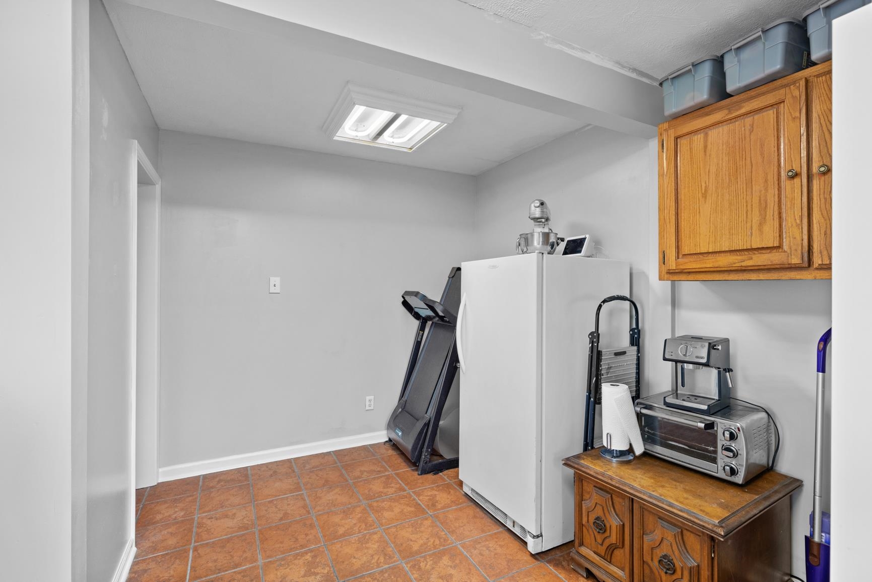 2640 Brighton-Clopton Road Brighton, TN 38011 - Photo 25 of 36 Kitchen with freestanding refrigerator, brown cabinetry, and tile patterned floors