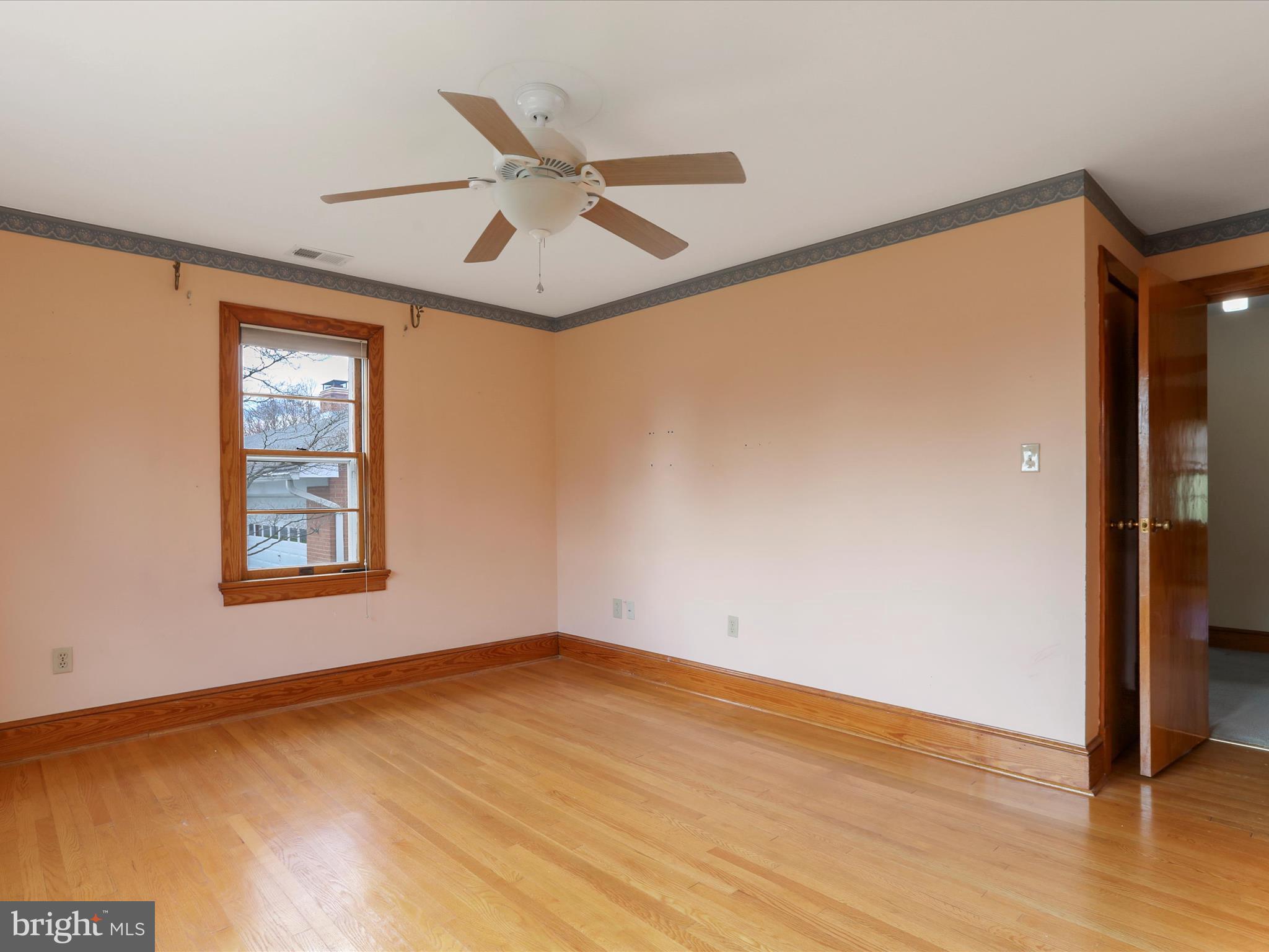 211 Broad Street Middletown, MD 21769 - Photo 13 of 35 an empty room with wooden floor fan and windows
