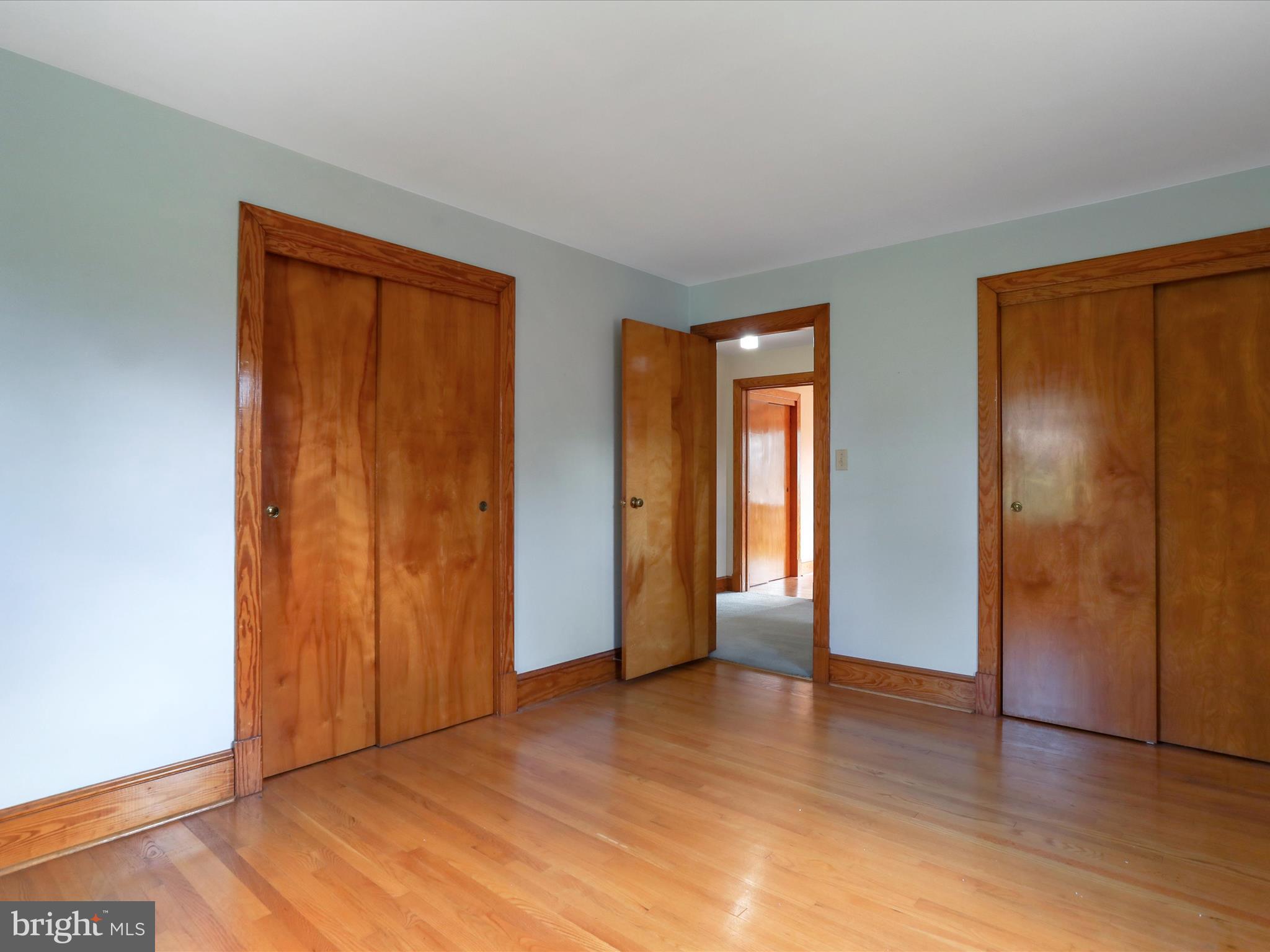 211 Broad Street Middletown, MD 21769 - Photo 17 of 35 an empty room with closet and wooden floor