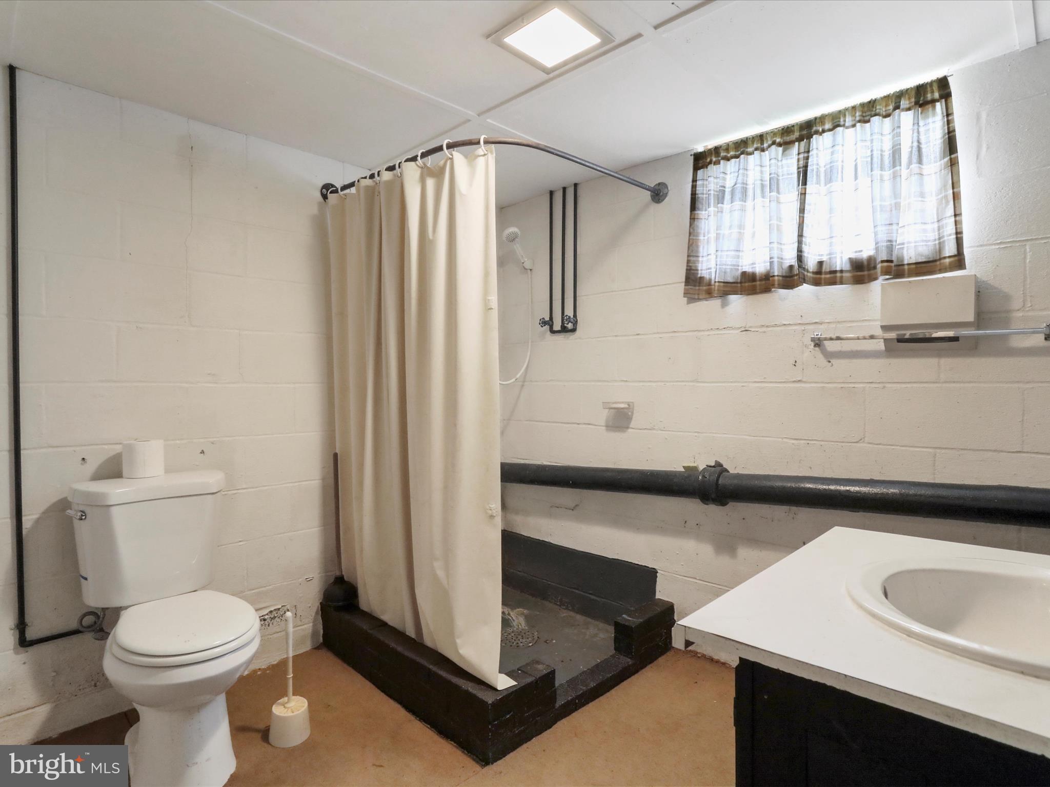 211 Broad Street Middletown, MD 21769 - Photo 28 of 35 a bathroom with a sink and a toilet