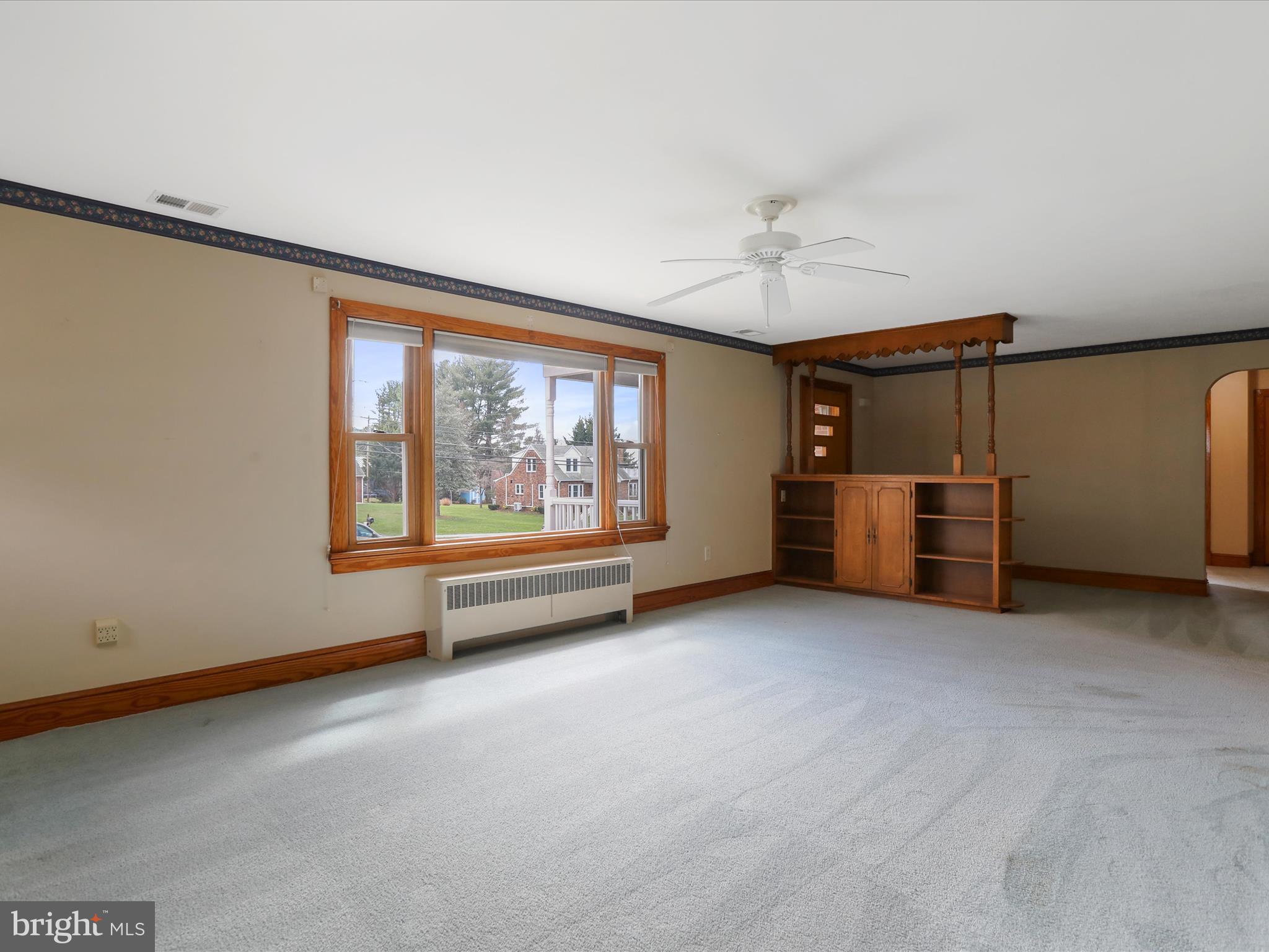 211 Broad Street Middletown, MD 21769 - Photo 8 of 35 an empty room with a fireplace and window