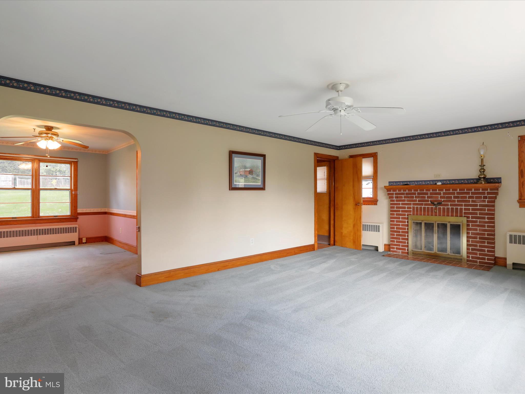 211 Broad Street Middletown, MD 21769 - Photo 9 of 35 an empty room with windows and fireplace