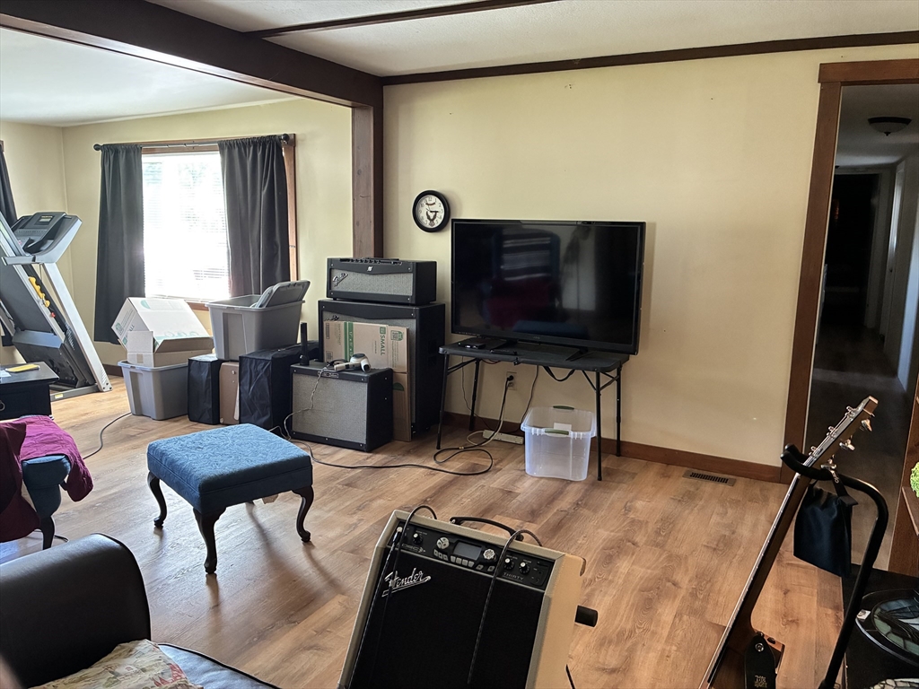 559 Tea Street, Unit 1 Charlemont, MA 01339 - Photo 6 of 14 a living room with furniture and a flat screen tv