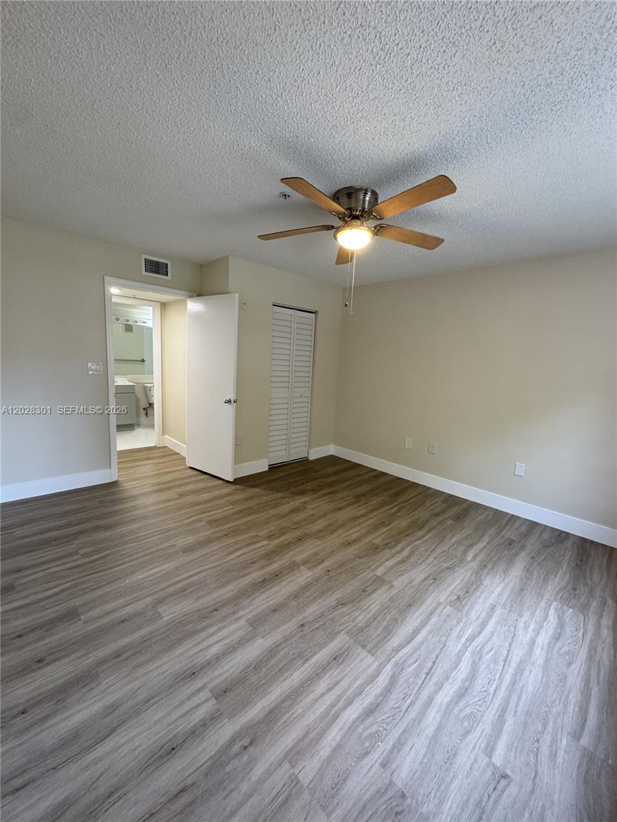 2021 Renaissance Boulevard, Unit 201 Miramar, FL 33025 - Photo 14 of 26 wooden floor in an empty room