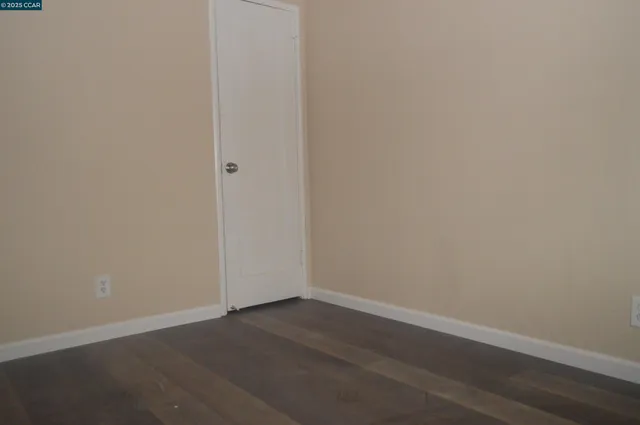 an empty room with wooden floor