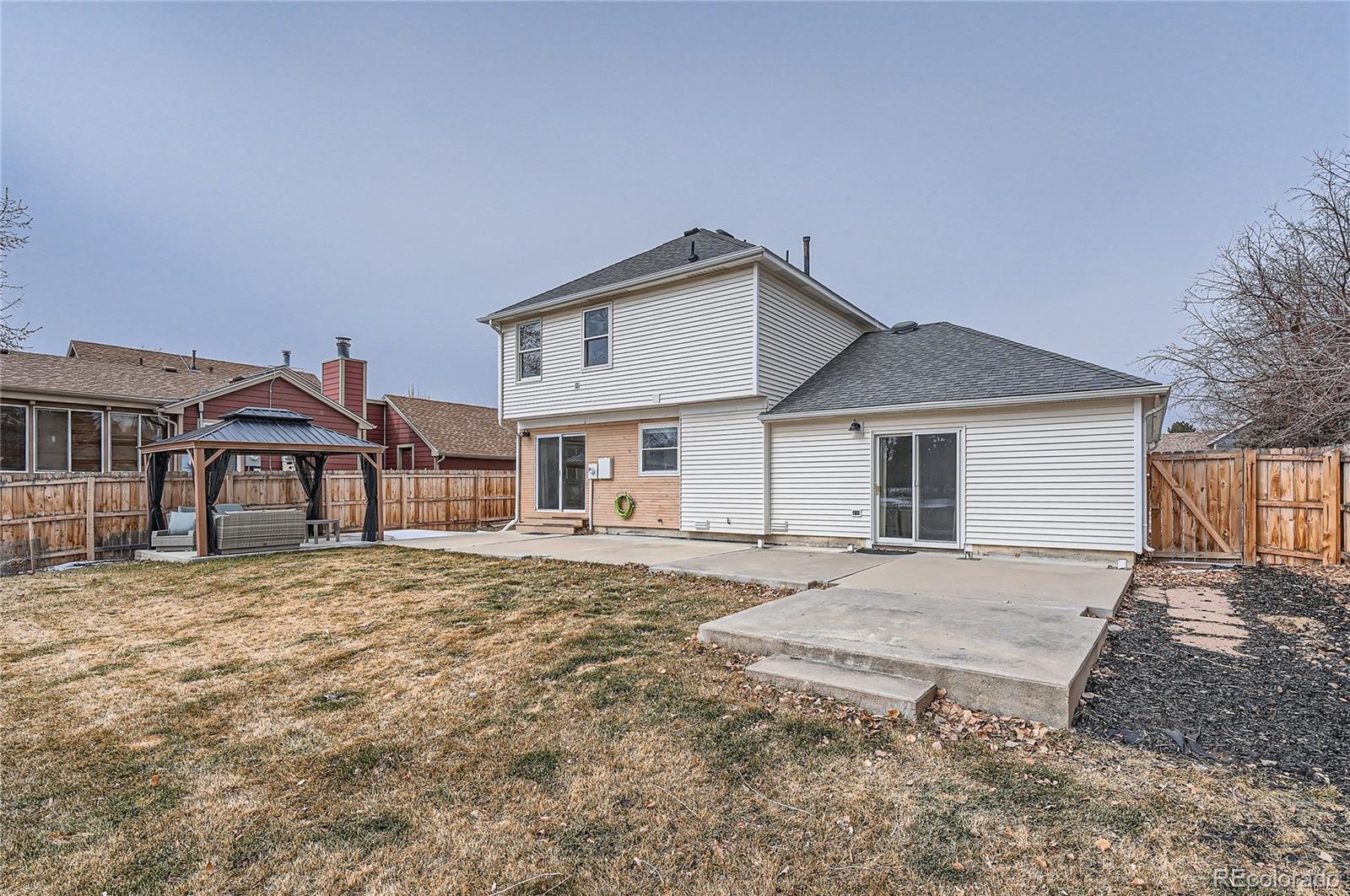 13158 West 62nd Drive Arvada, CO 80004 - Photo 29 of 35 a front view of a house with a yard