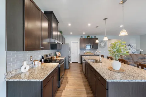 a spacious bedroom with a bed and a flat screen tv