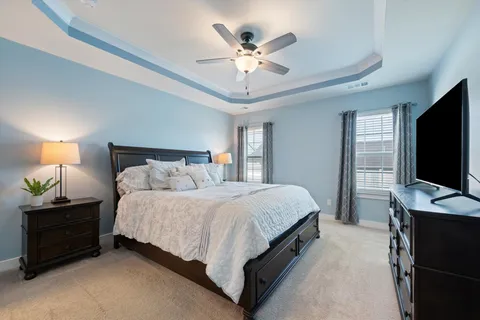 a bedroom with a bed and a desk