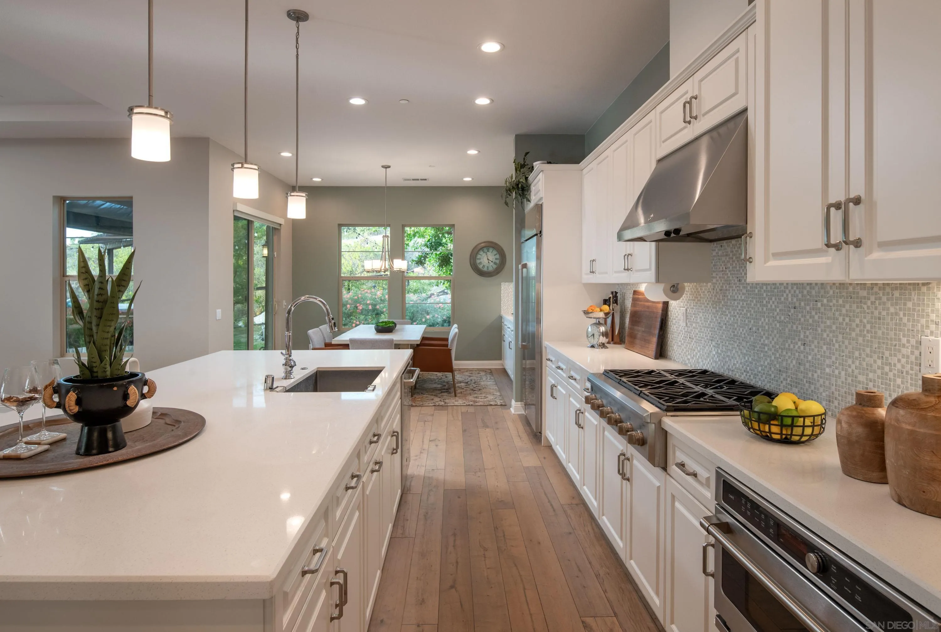 14516 Highcrest Court Poway, CA 92064 - Photo 15 of 71 a large white kitchen with lots of counter space a sink and appliances