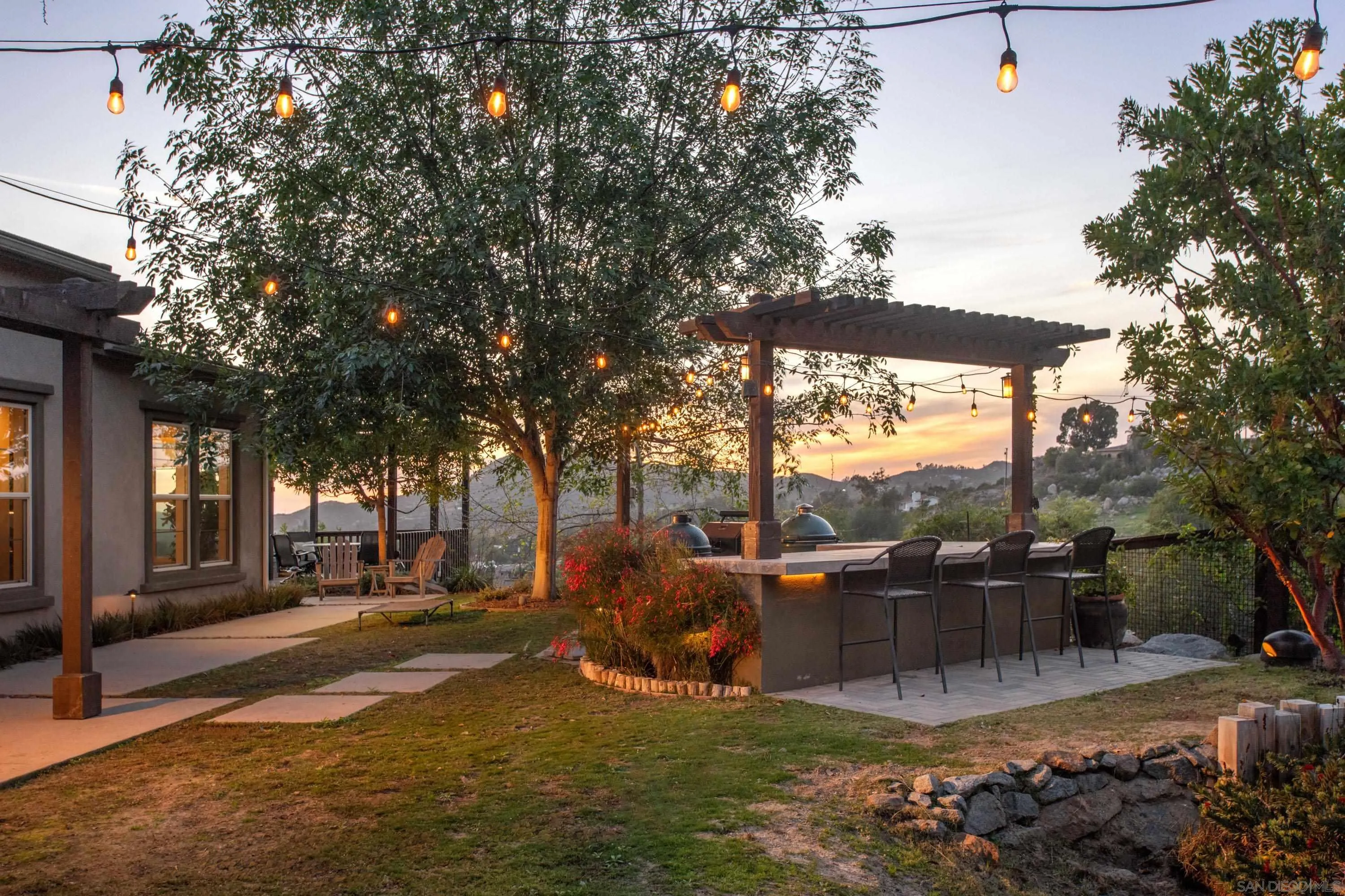 14516 Highcrest Court Poway, CA 92064 - Photo 42 of 71 a view of a patio with table and chairs potted plants and large tree