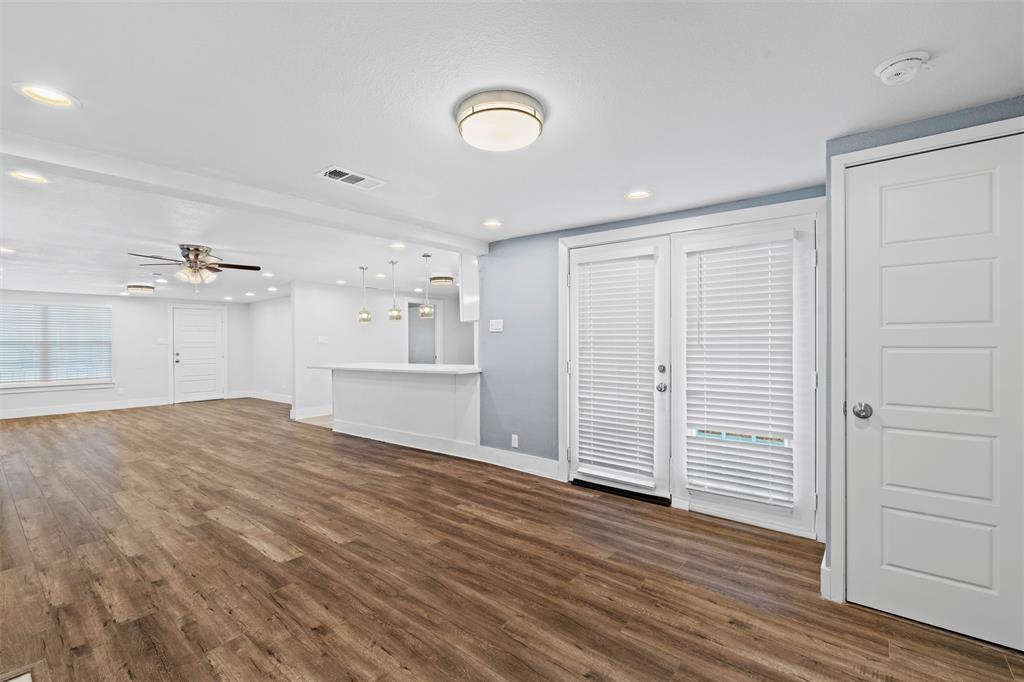 3514 Larry Street Rowlett, TX 75088 - Photo 11 of 27 an empty room with wooden floor and windows