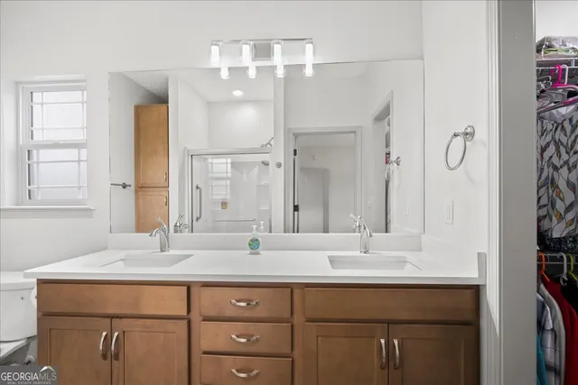 a bathroom with a glass shower door