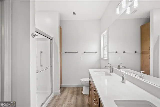 a front view of a house with a garden and trees