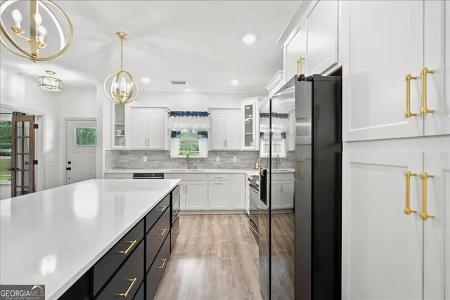a kitchen with stainless steel appliances granite countertop a sink a cabinets and window