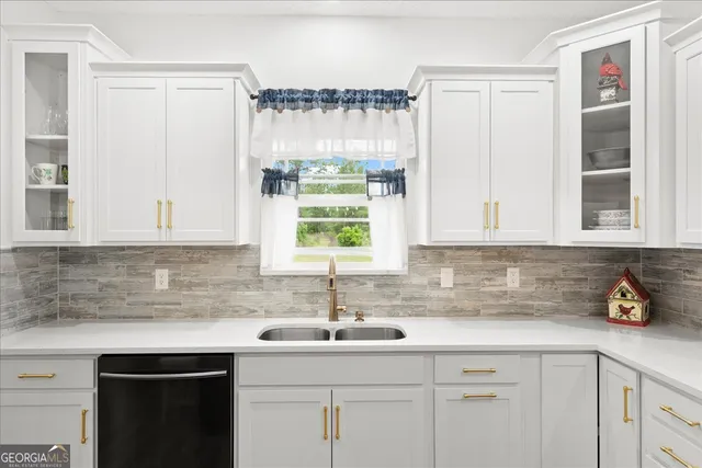 a kitchen with a sink appliances and cabinets