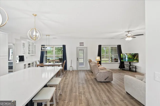 a view of a dining room with furniture window and wooden floor