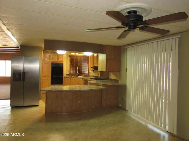 a view of a kitchen with a sink and a refrigerator