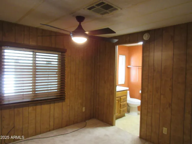 a bathroom with a sink and mirror with toilet