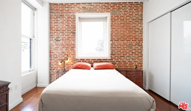 a bedroom with a bed and a flat tv screen