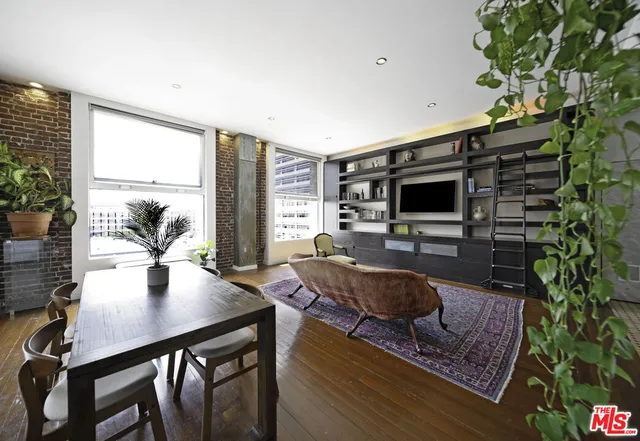 a dining room with furniture and wooden floor