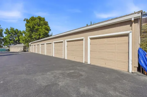 a view of house with garage and yard