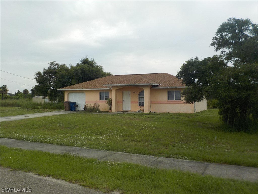 16981 First Street Alva, FL 33920 - Photo 1 of 12 a front view of a house with a garden