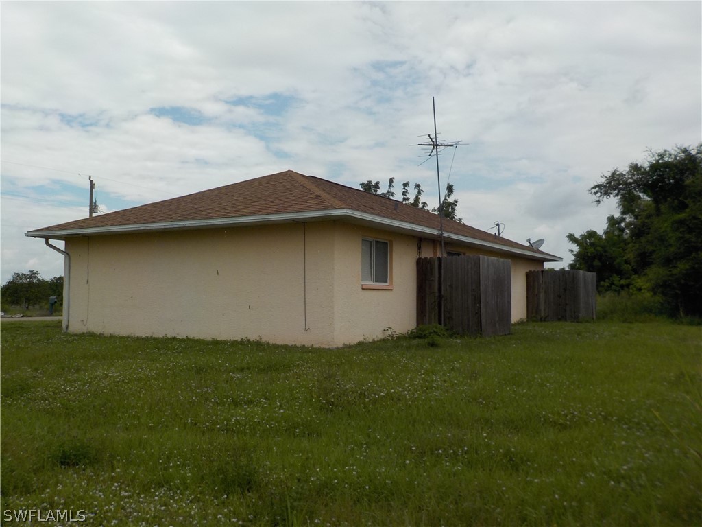 16981 First Street Alva, FL 33920 - Photo 3 of 12 a backyard of a house with lots of green space and garden