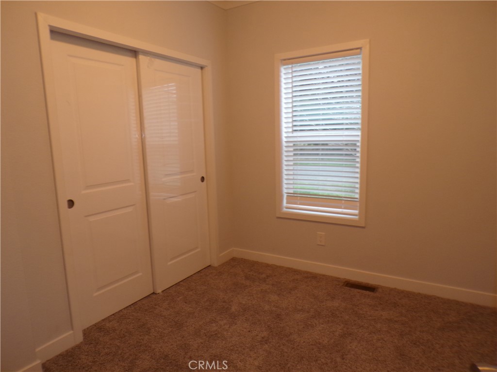 13586 Fair Oak Road Clearlake, CA 95422 - Photo 11 of 15 a view of an empty room with closet and a window