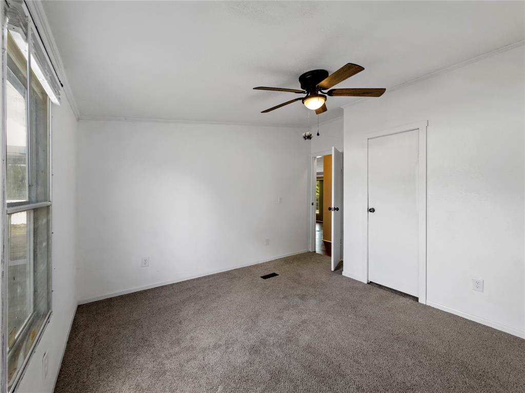401 Barker Street Bowie, TX 76230 - Photo 18 of 24 a view of a livingroom with a ceiling fan and window