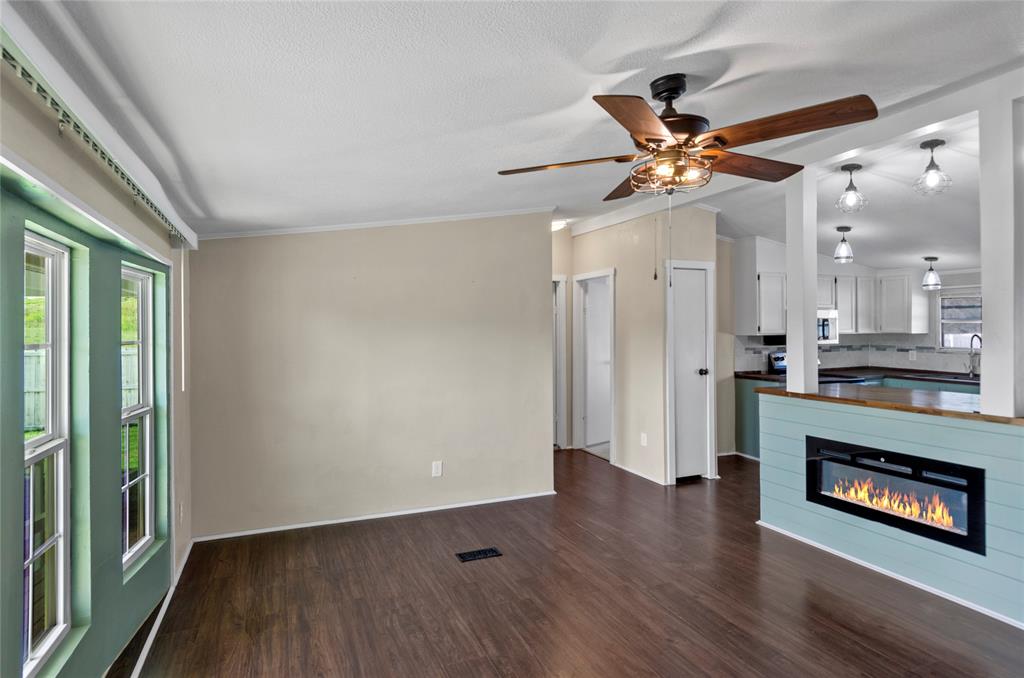 401 Barker Street Bowie, TX 76230 - Photo 8 of 24 wooden floor in an empty room with a window