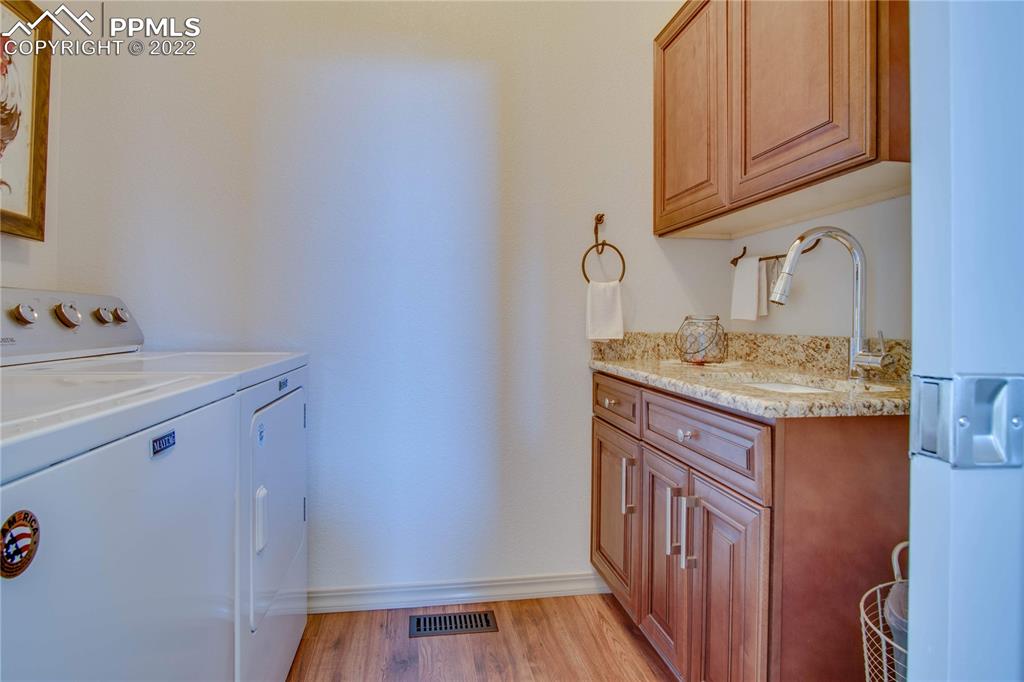 124 Rocchio Drive Florence, CO 81226 - Photo 16 of 34 a bathroom with a granite countertop sink and a mirror