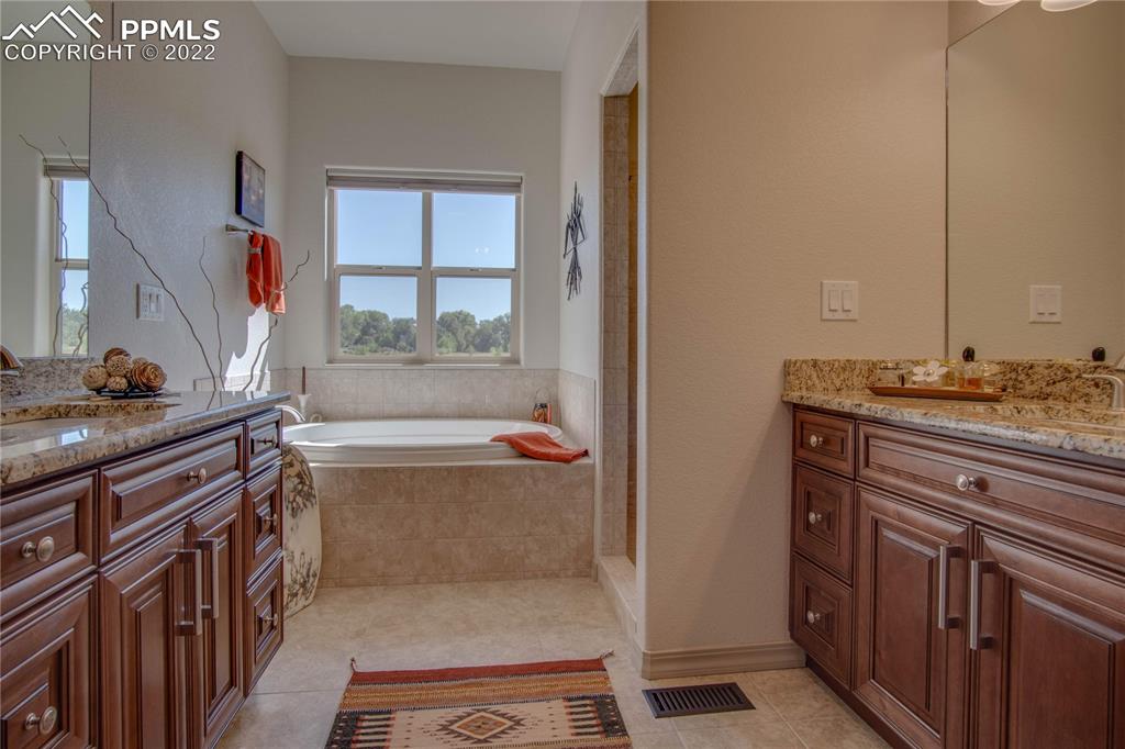 124 Rocchio Drive Florence, CO 81226 - Photo 21 of 34 a bathroom with a tub sink and mirror
