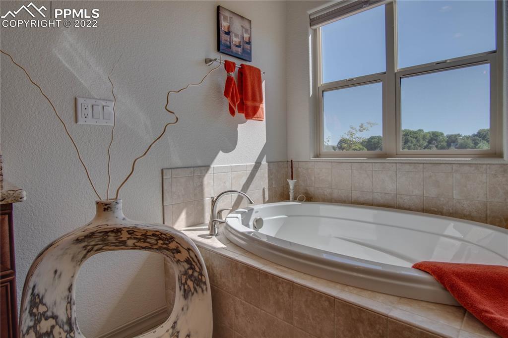 124 Rocchio Drive Florence, CO 81226 - Photo 24 of 34 a bathroom with a bathtub and a window