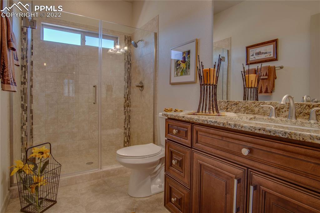 124 Rocchio Drive Florence, CO 81226 - Photo 32 of 34 a bathroom with a granite countertop sink toilet and shower