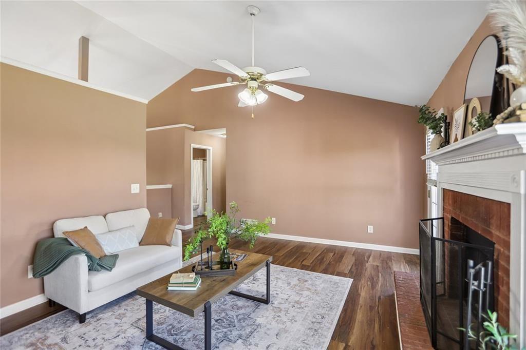 9720 Poole Road Villa Rica, GA 30180 - Photo 6 of 40 a living room with furniture a fireplace and a flat screen tv