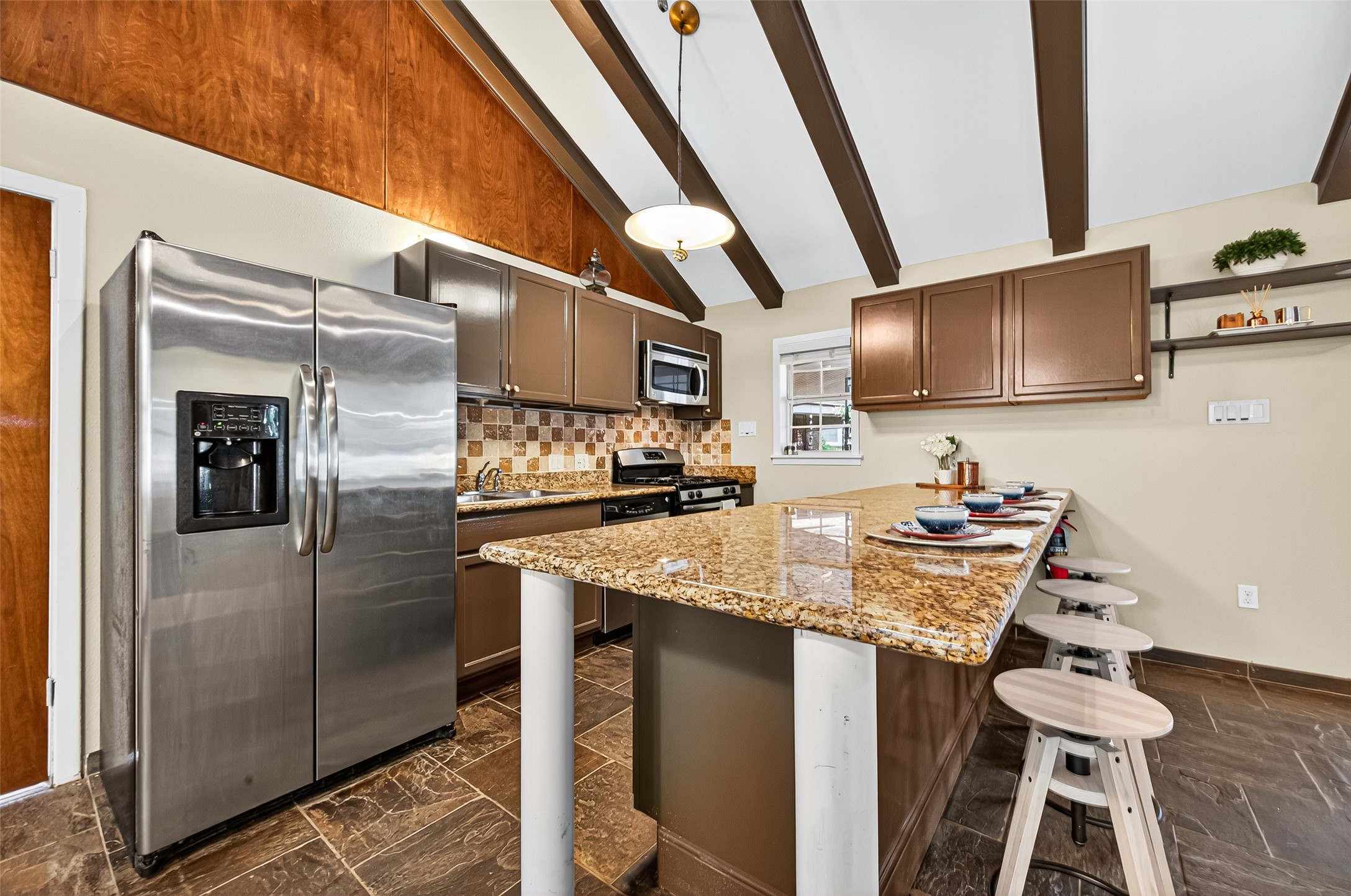 4628 Roseneath Drive, Unit A Houston, TX 77021 - Photo 3 of 21 Galley kitchen with stainless steel appliances: Refrigerator, Gas Stove/Oven Range, Microwave, and Dishwasher.