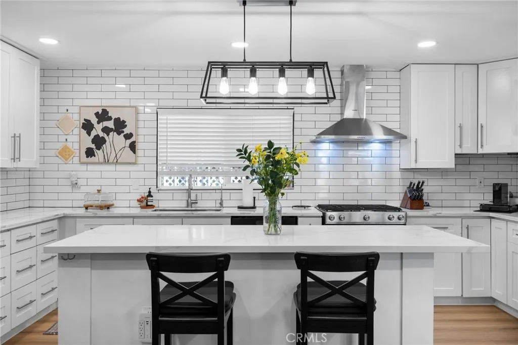 1051 Site, Unit 38 Brea, CA 92821 - Photo 13 of 45 a kitchen with stainless steel appliances a sink a table and chairs in it
