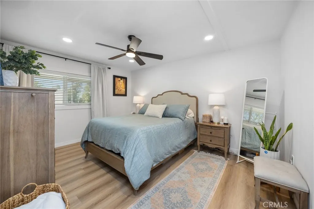 1051 Site, Unit 38 Brea, CA 92821 - Photo 23 of 45 a bedroom with a large bed wooden floor and windows