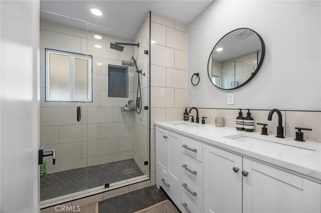 1051 Site, Unit 38 Brea, CA 92821 - Photo 32 of 45 a bathroom with a granite countertop sink mirror and shower