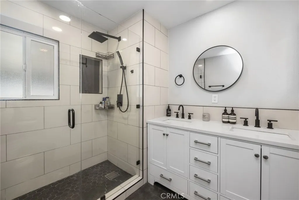 1051 Site, Unit 38 Brea, CA 92821 - Photo 33 of 45 a bathroom with a double vanity sink mirror and shower