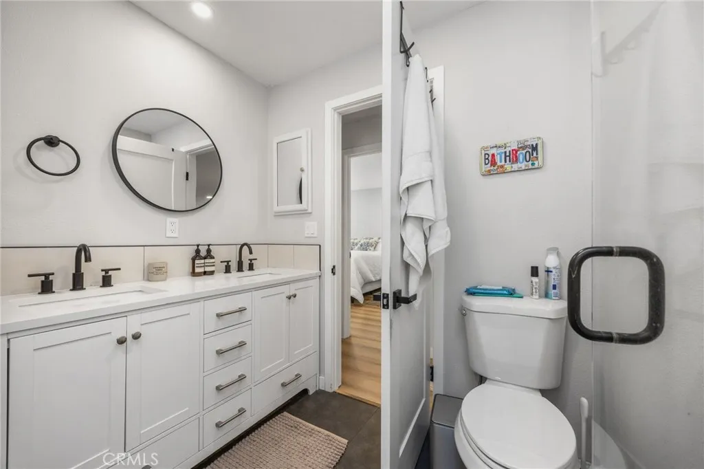1051 Site, Unit 38 Brea, CA 92821 - Photo 34 of 45 a bathroom with a toilet sink vanity granite and a mirror