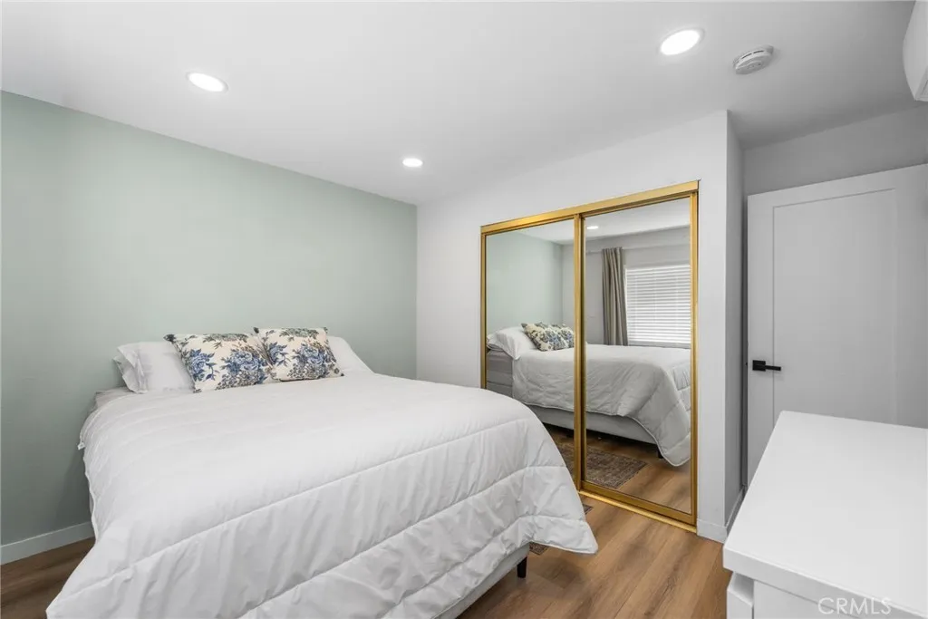 1051 Site, Unit 38 Brea, CA 92821 - Photo 37 of 45 a bedroom with a bed and wooden floor