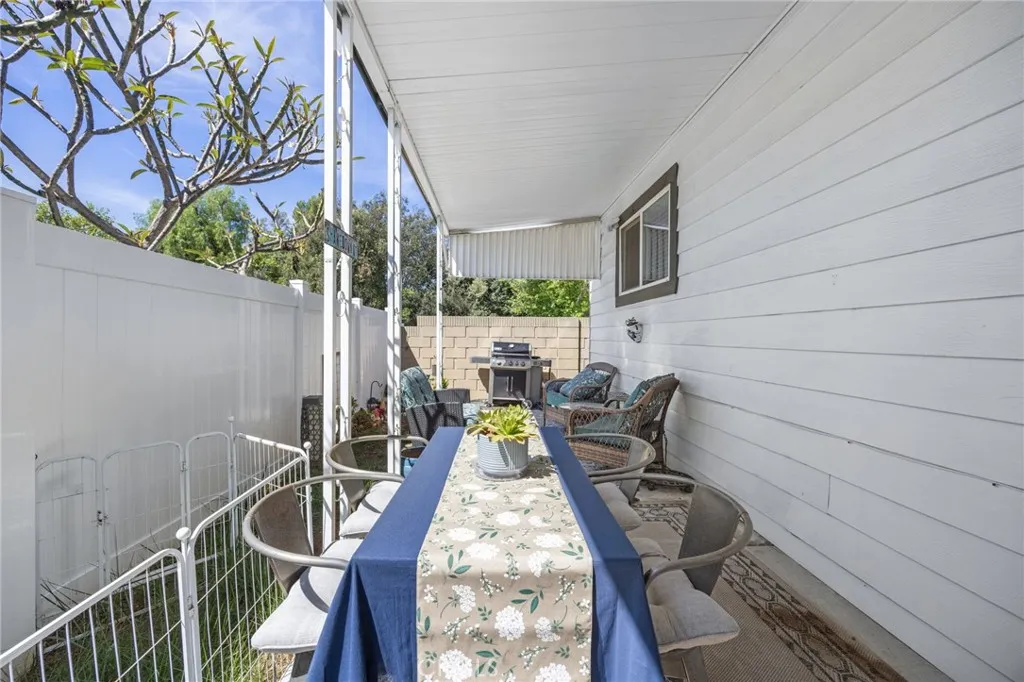 1051 Site, Unit 38 Brea, CA 92821 - Photo 41 of 45 a view of a patio with table and chairs and wooden floor