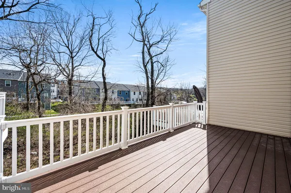 a view of balcony with wooden floor and fence