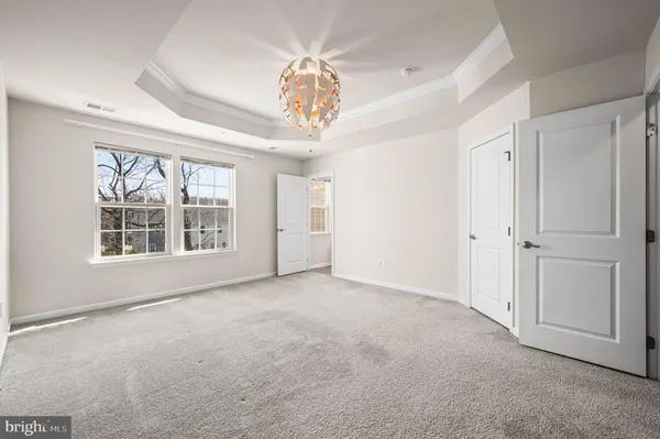 an empty room with windows and entrance