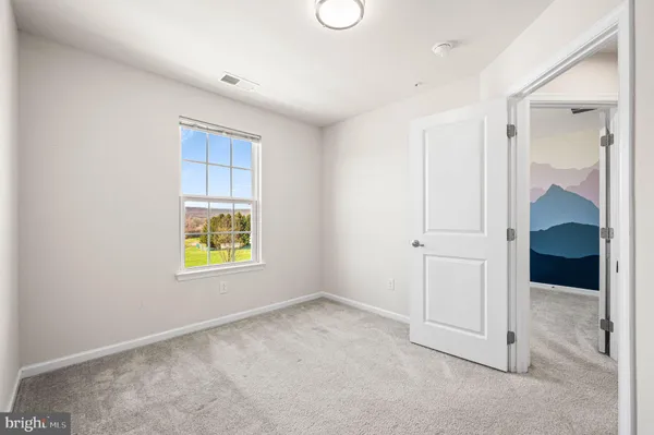 an empty room with a bathroom and a sink