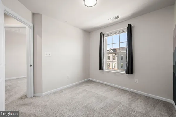 an empty room with windows and closet