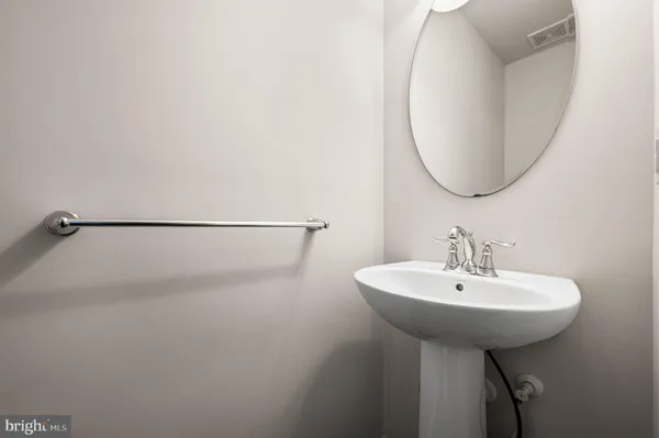 a bathroom with a sink a mirror and a window