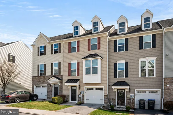 a front view of a residential apartment building with a yard