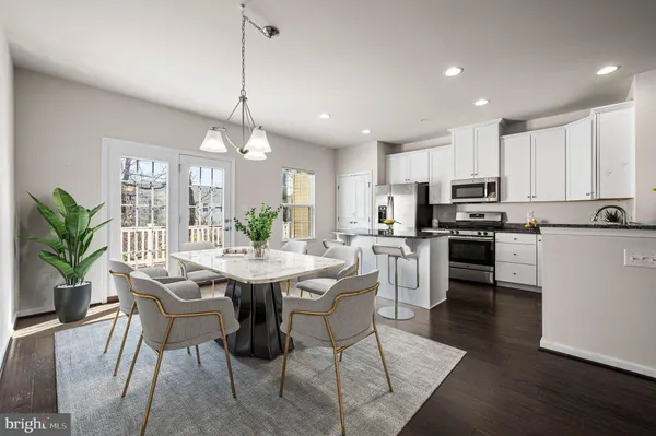 a kitchen with kitchen island granite countertop a center island a sink stainless steel appliances and cabinets